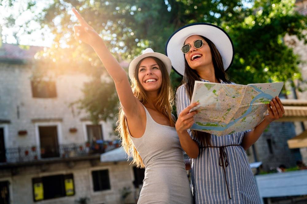 Friends touring vacation destination with a map