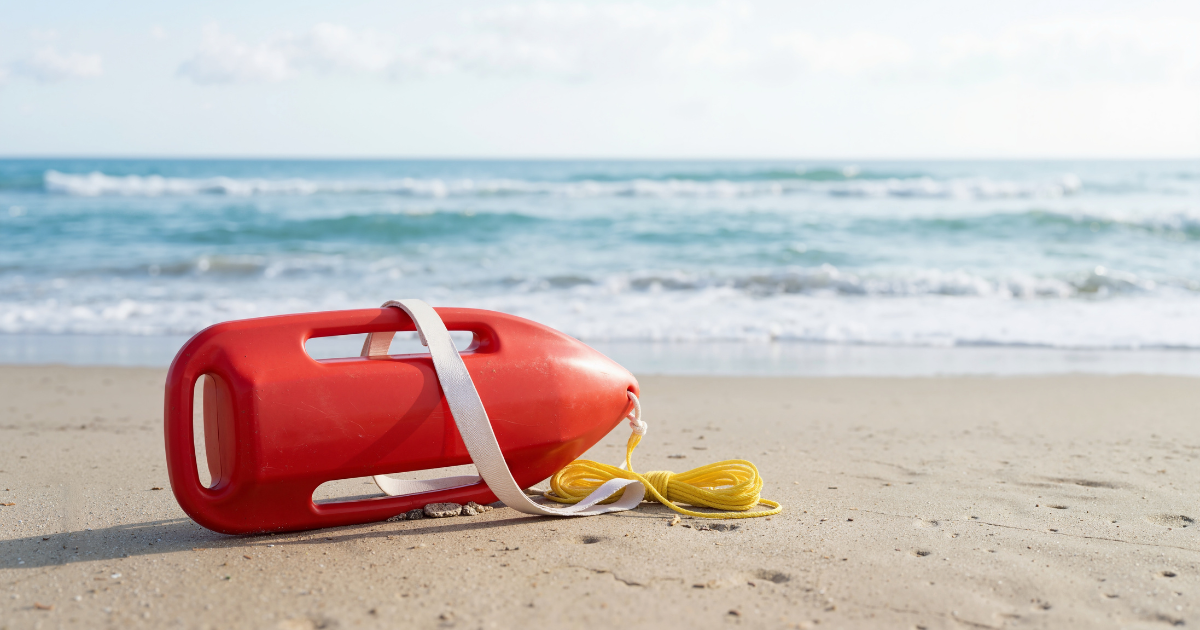 red life saving floatation device on beach