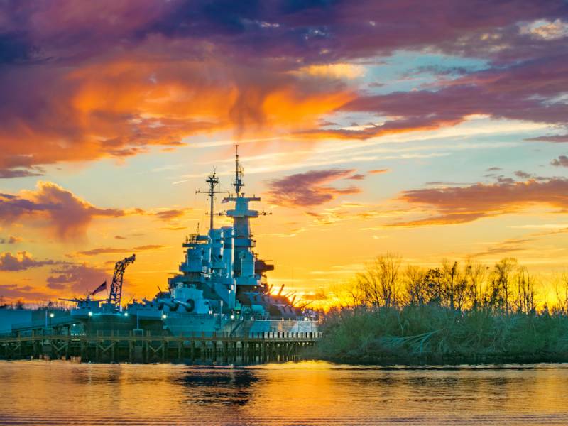USS North Carolina battleship at sunset