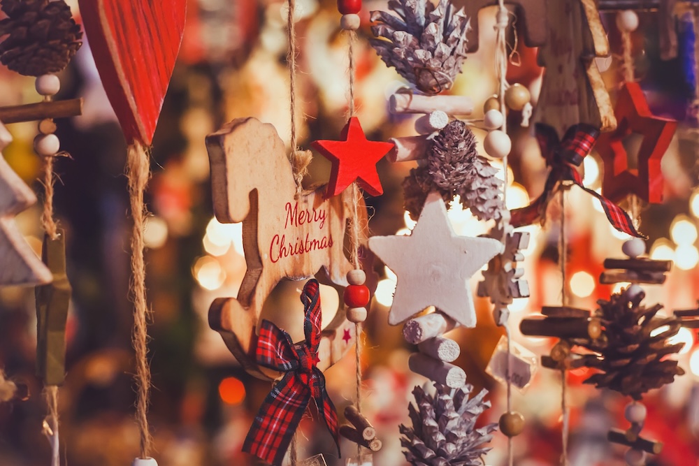 Closeup of wooden holiday ornaments in a Christmas shop