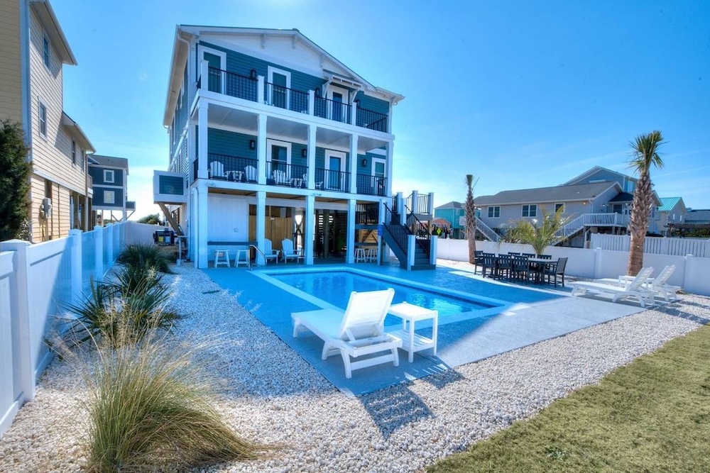 Vacation rental exterior with pool and outdoor seating