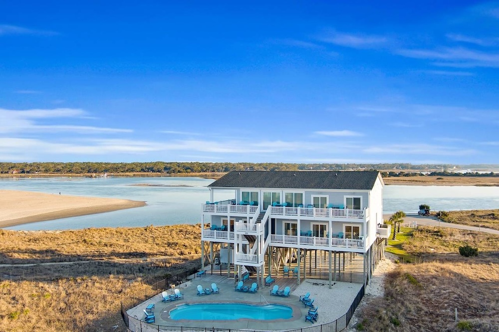 Aerial photo of vacation rental with inlet in background