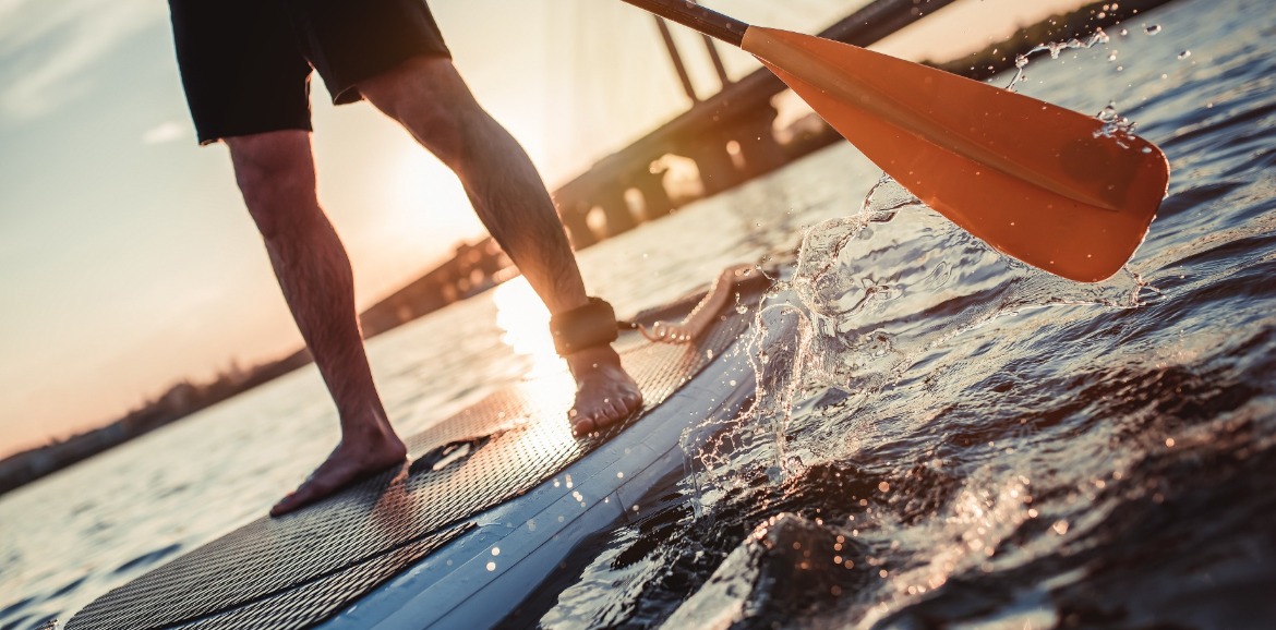 man enjoying stand up paddle boarding | Better Beach Rentals