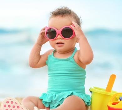baby wearing sunglasses on the beach | better beach rentals
