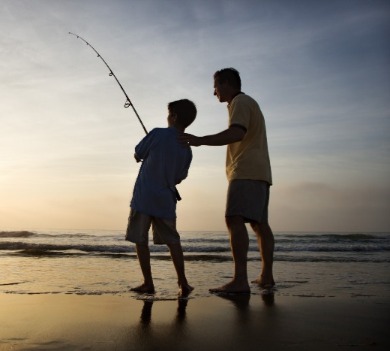 father and son fishing on the beach | Better Beach Rentals