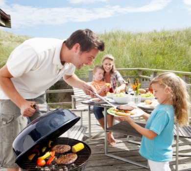 family cooking on the grill at Oak Island vacation rental | Better Beach Rentals